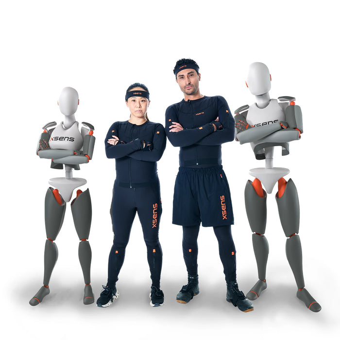 Two people wearing dark blue athletic suits with 'Xsens' branding, standing between two mannequins also wearing 'Xsens' suits.